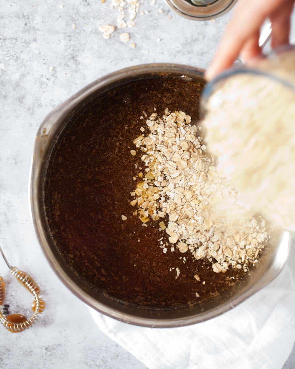 Step by Step - adding oats to melted butter, sugar, and syrup in a pan