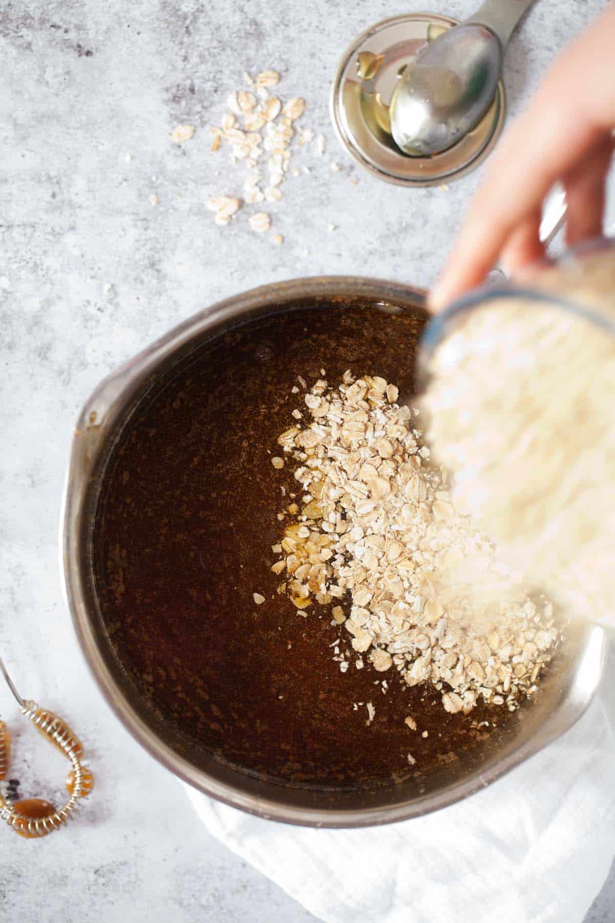 Step by Step - adding oats to melted butter, sugar, and syrup in a pan