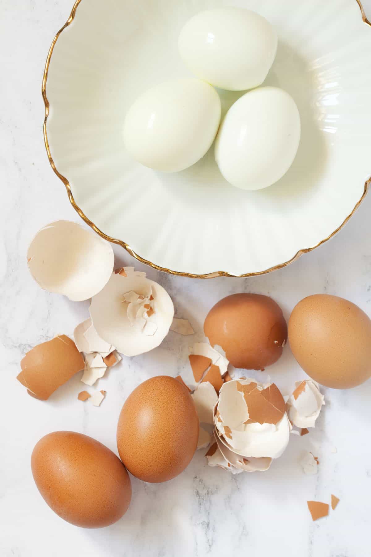 Hard boiled eggs being removed from their shells