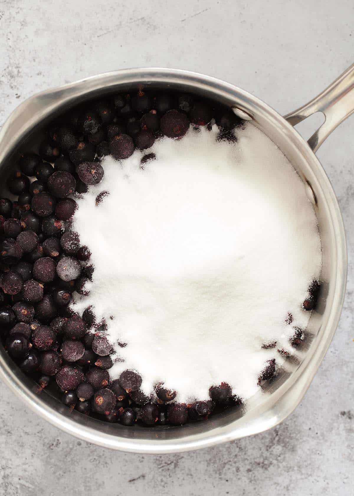 frozen fruit and sugar in a saucepan