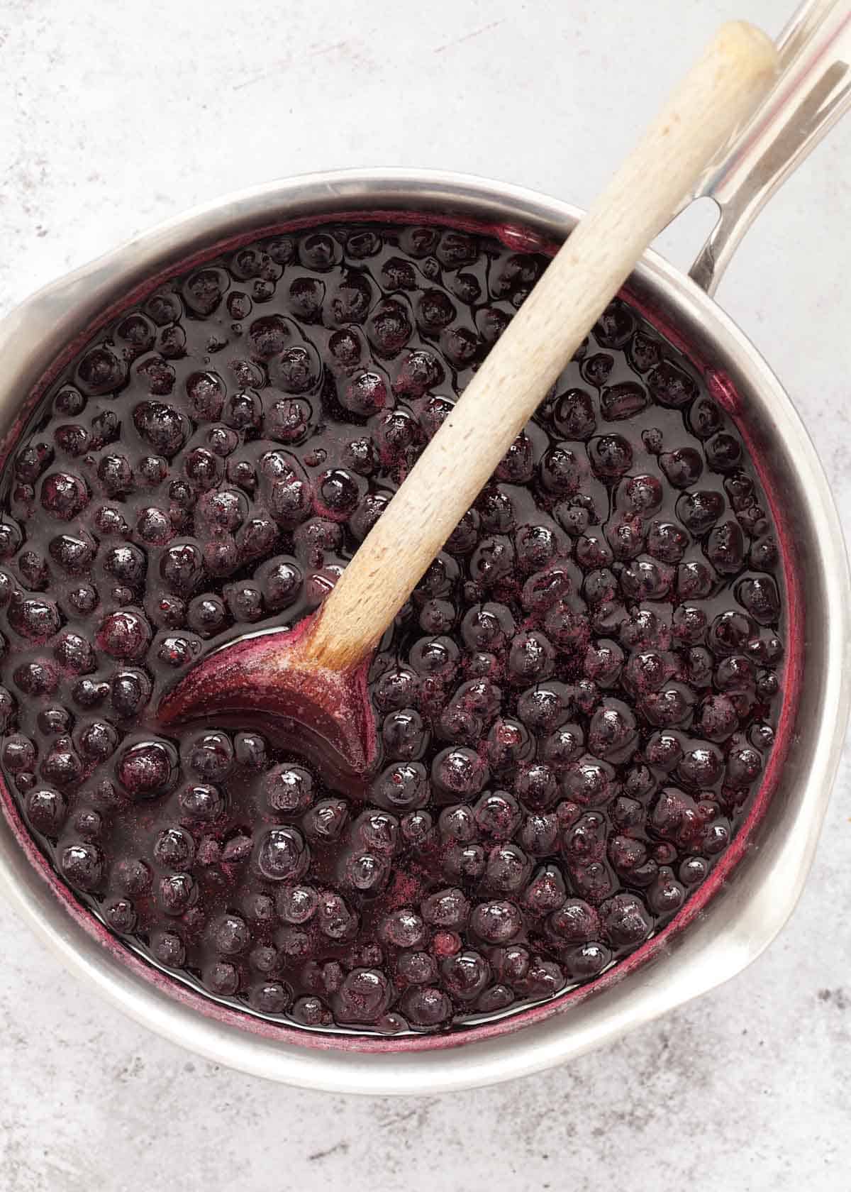 Cooked blackcurrants in a saucepan