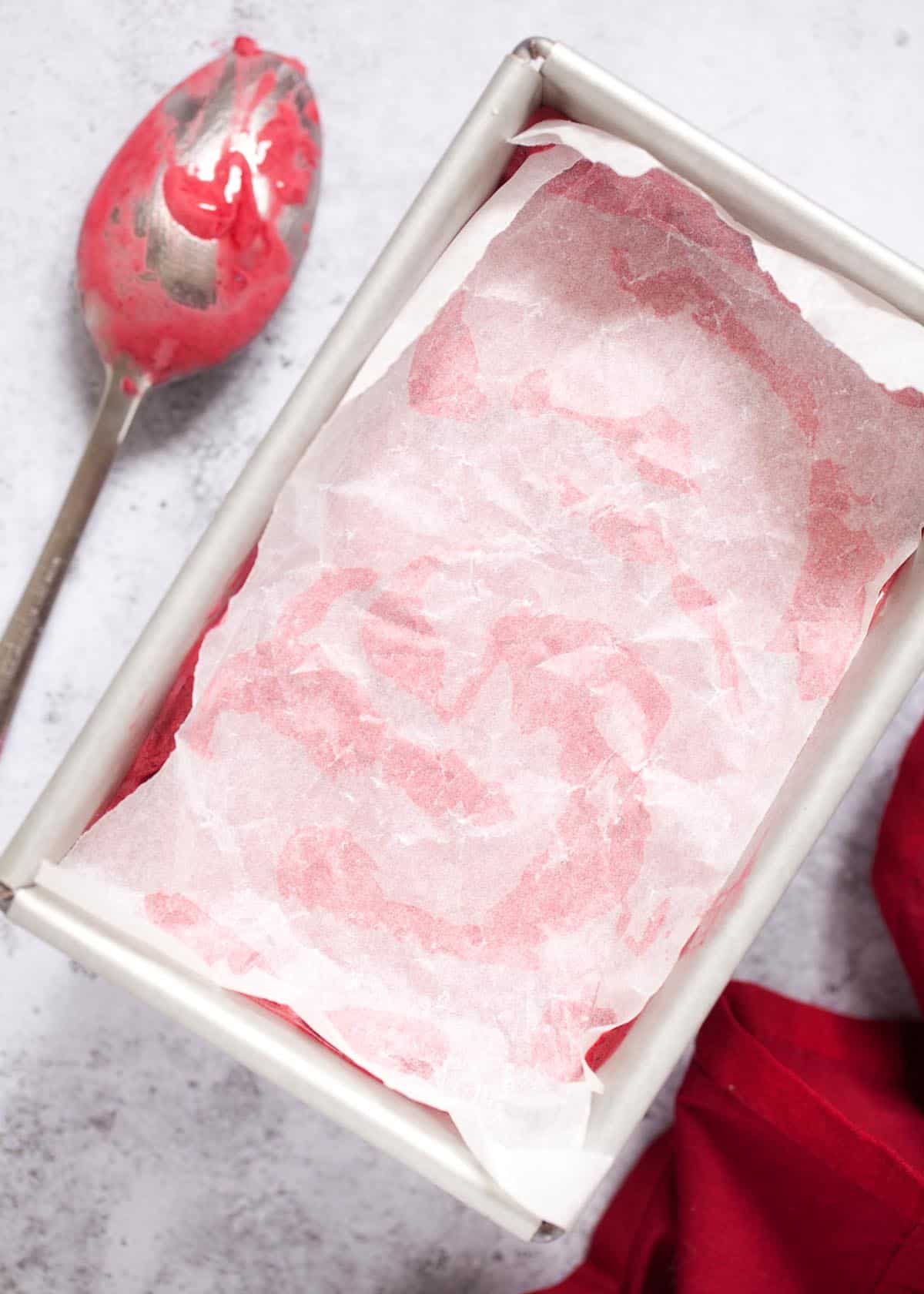 Fruit sorbet in a metal tin with parchment paper on top