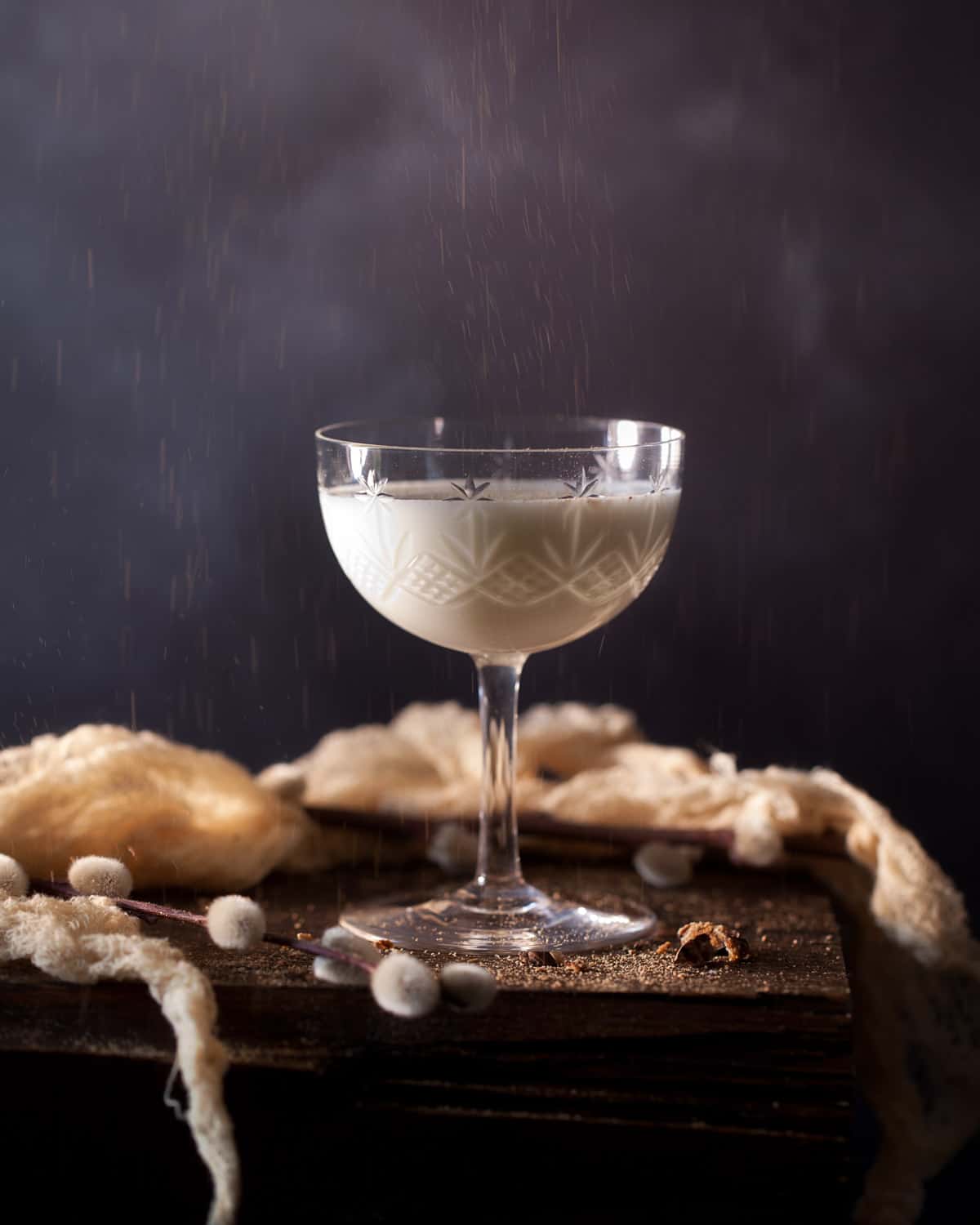 Grated nutmeg being dusted onto a gin Alexander cocktail 