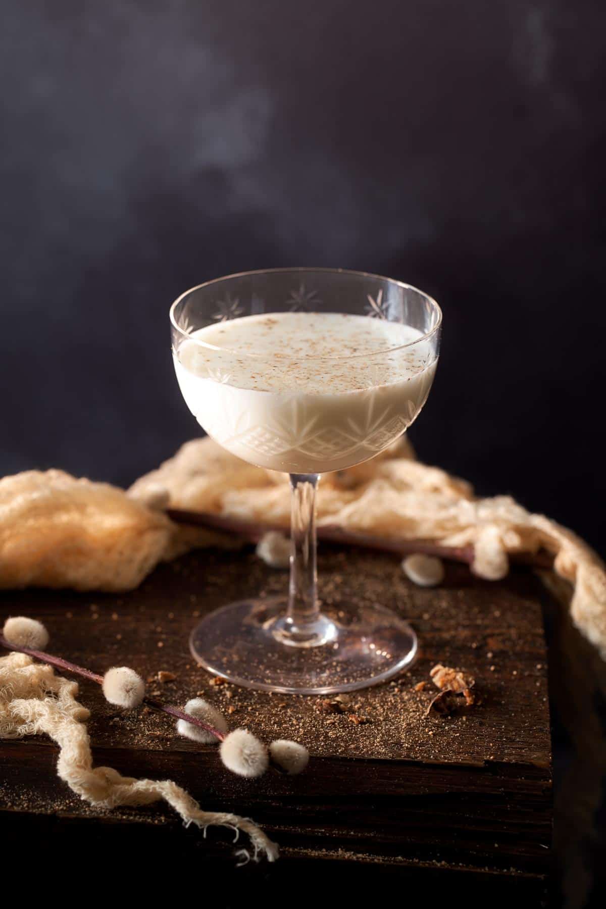 A gin alexander cocktail in a vintage glass and dusted with nutmeg.