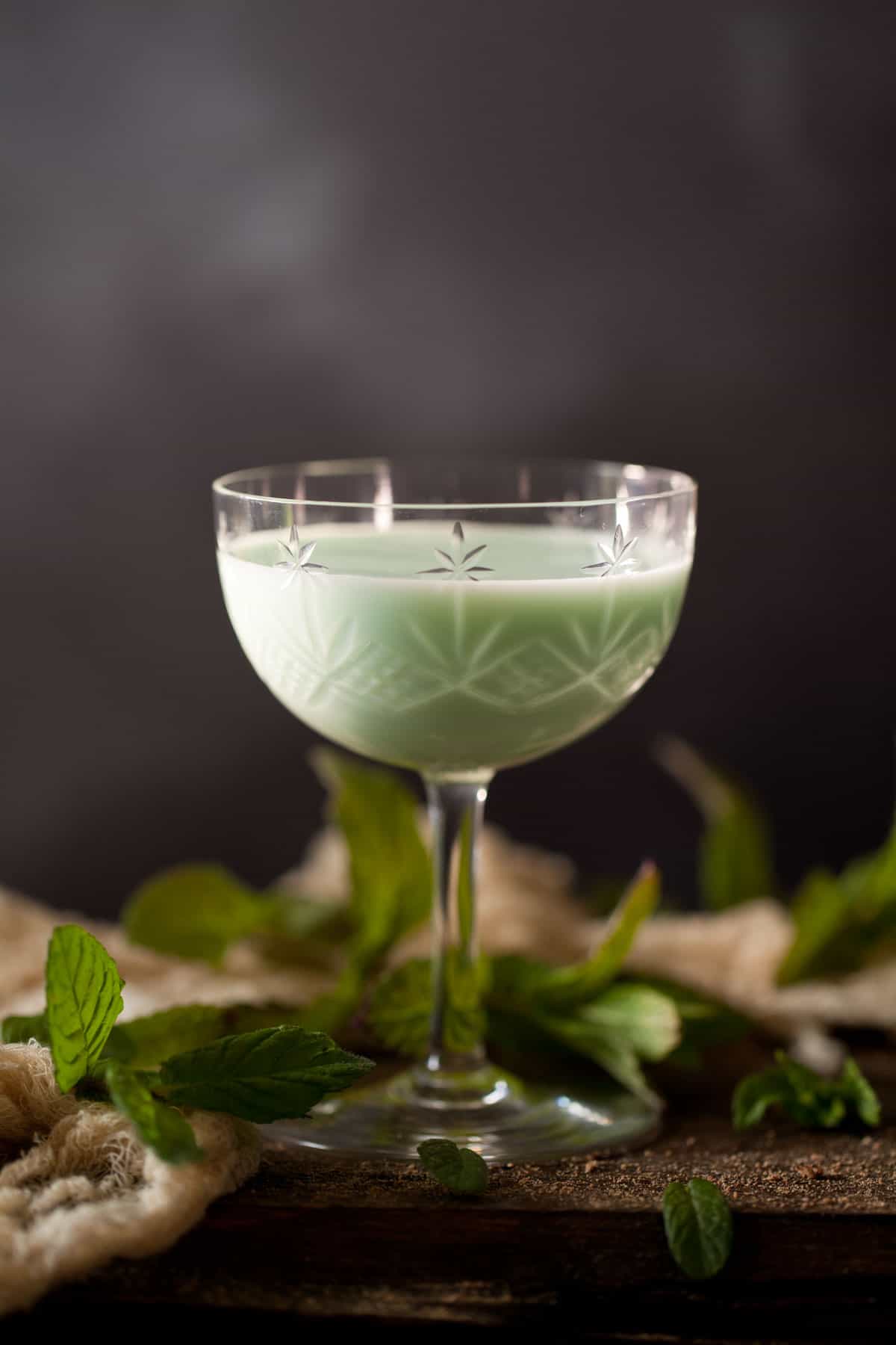 A creamy gin alexander flavoured with green creme de menthe. Served in a vintage cocktail glass