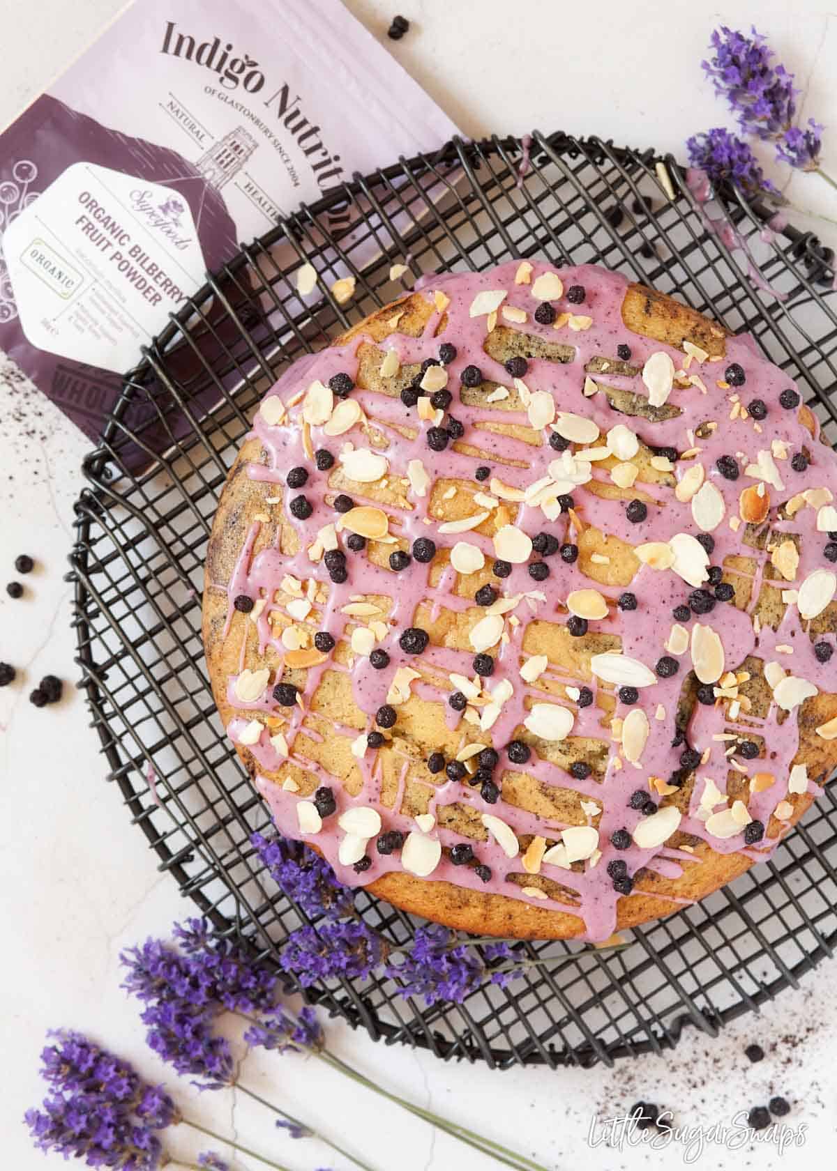 Dairy free Eggless blueberry cake on a rack with packets of ingredients