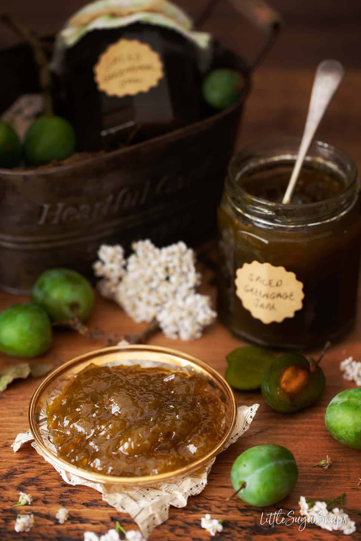 Greengage jam on a vintage saucer with an open jam jar behind.