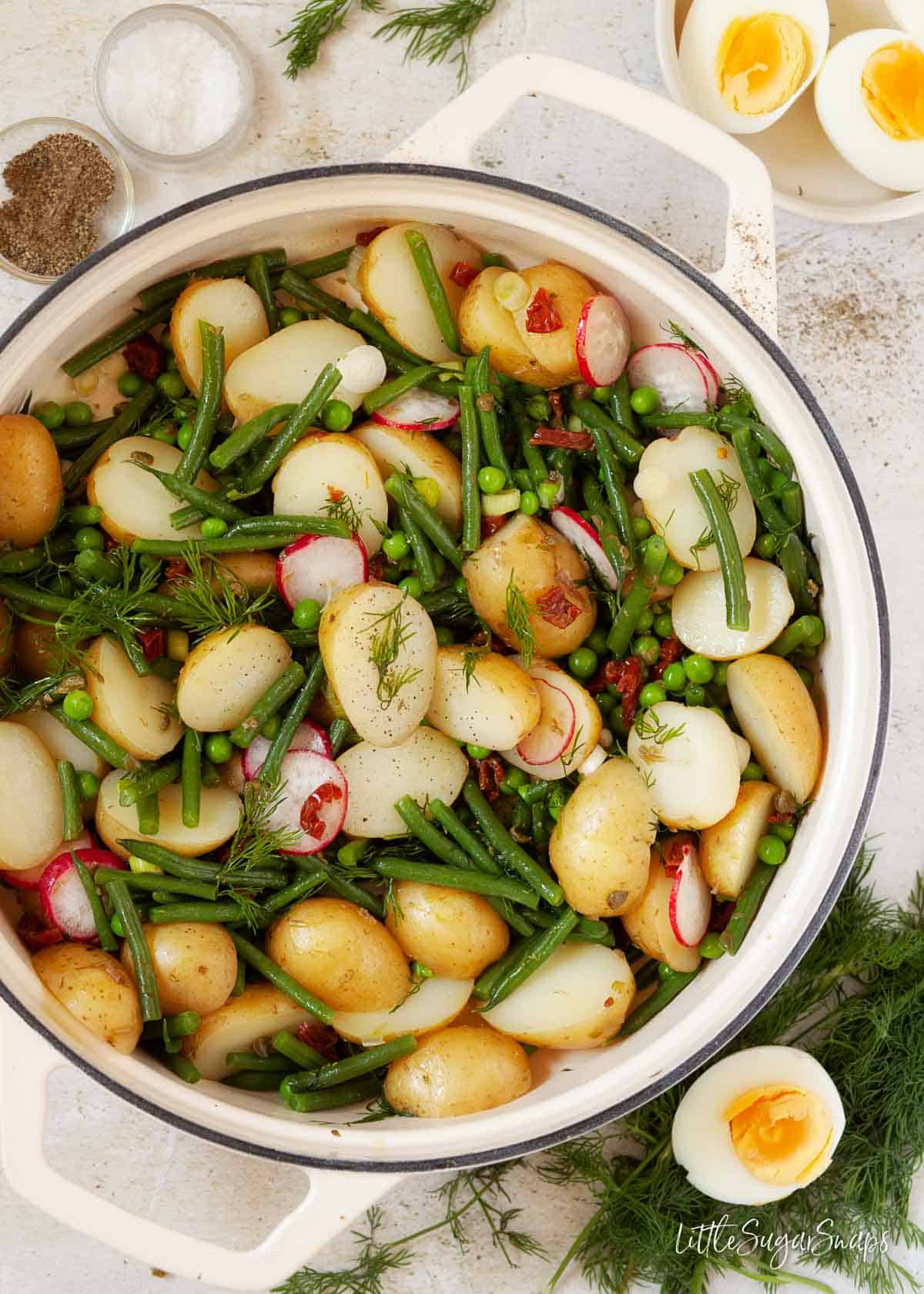 Potato salad and green vegetables with dill and sundried tomatoes