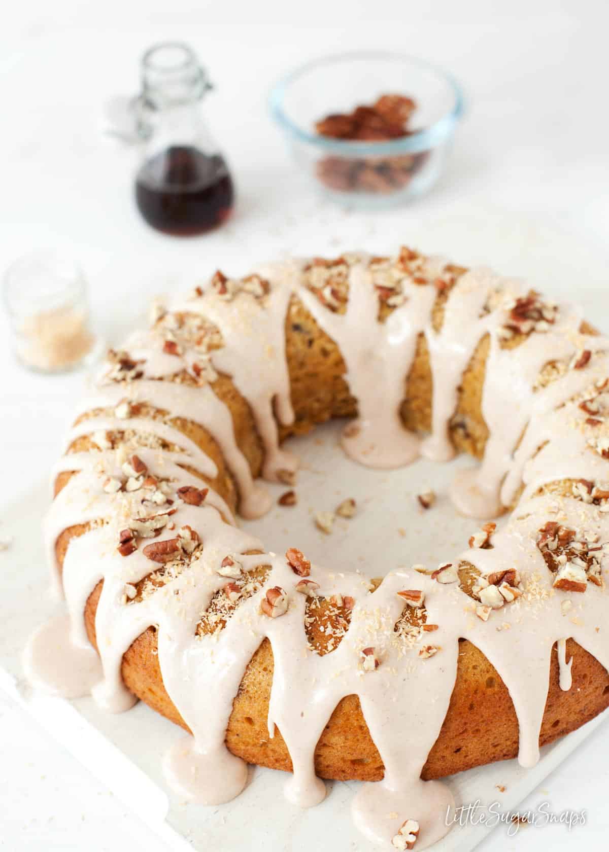 Freshly decorated spice bundt cake on a wooden board.