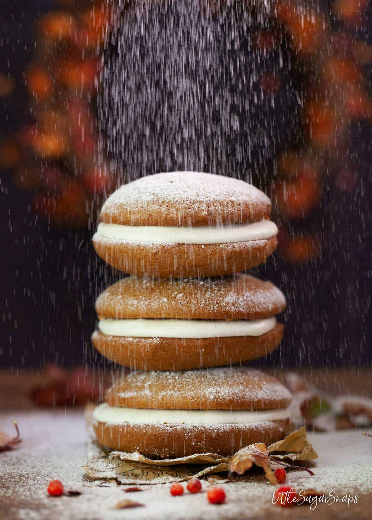 Dredging pumpkin flavoured Maine whoopie pies with icing sugar