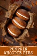 Three pumpkin whoopie pies in a tin with text overlay