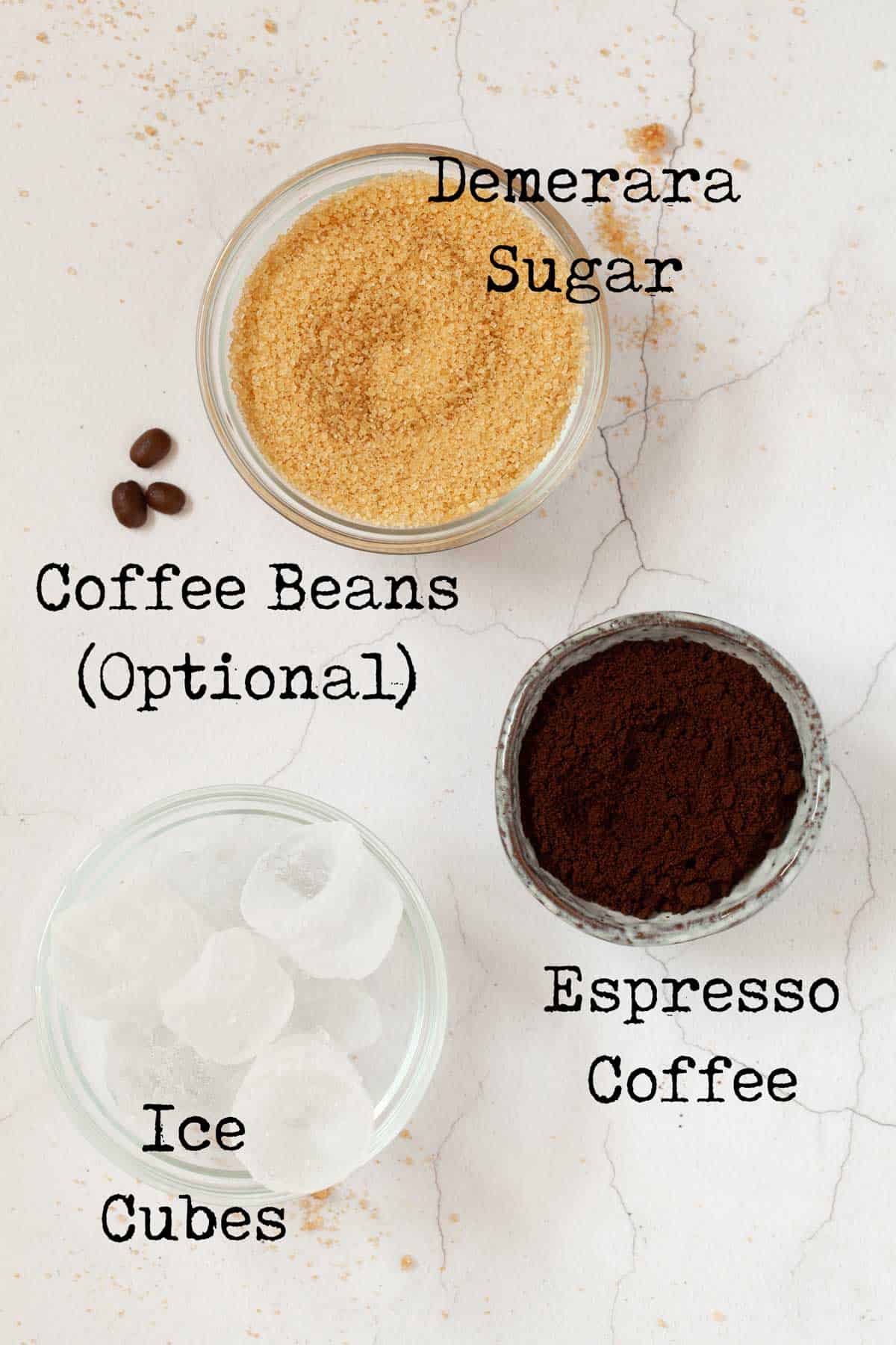 Ingredients for iced coffee: ground coffee, ice, sugar, coffee beans