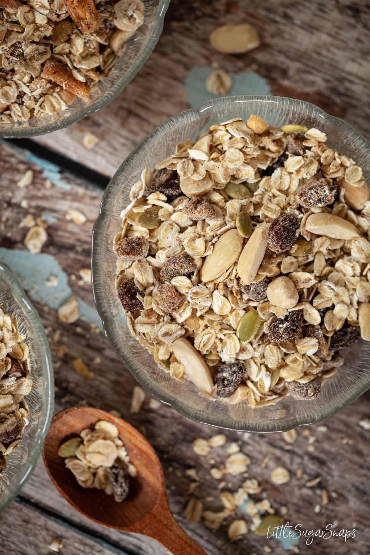 Bowls of homemade toasted muesli with dates, raisins, almonds and hazelnuts