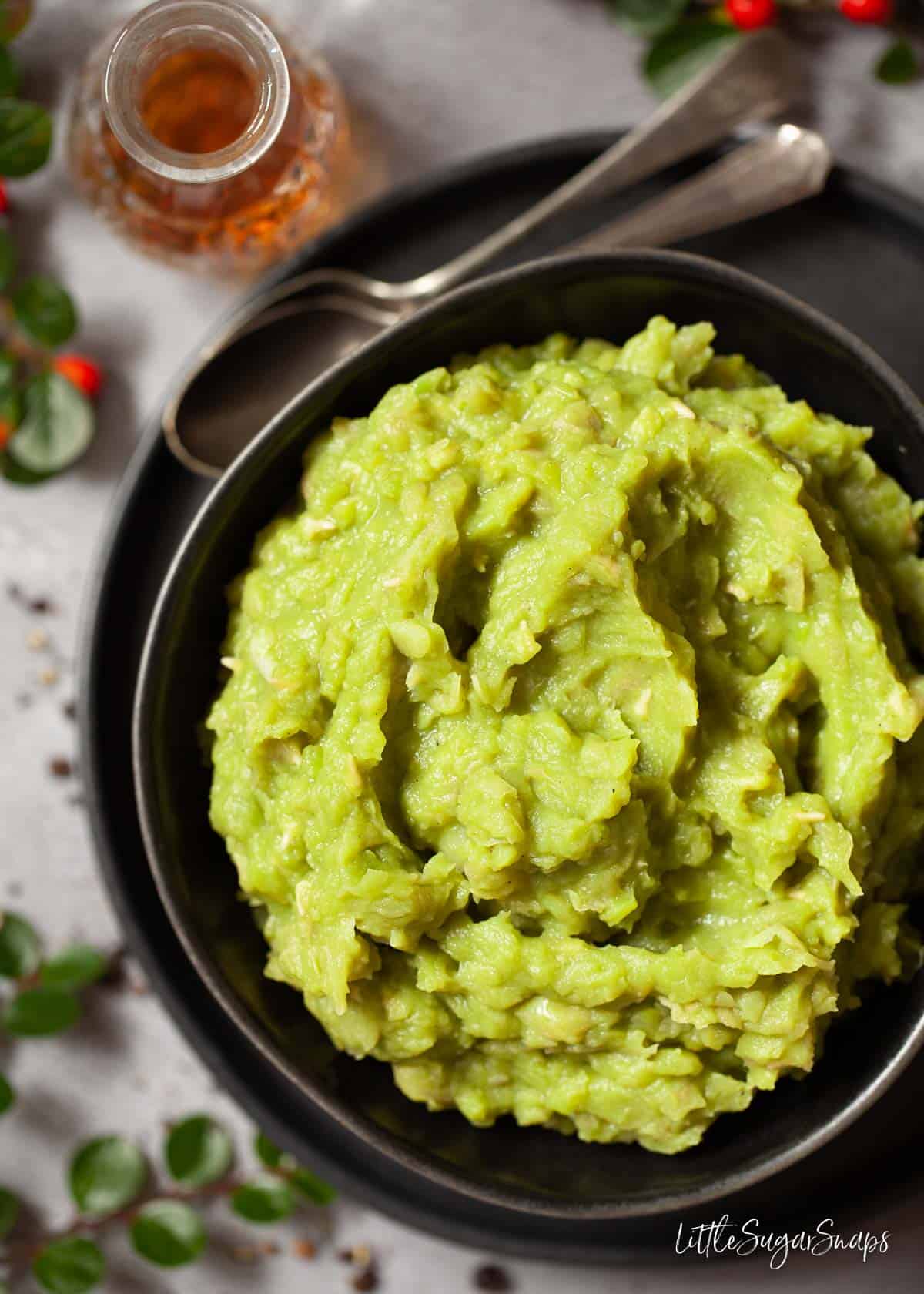 A serving bowl filled with homemade mushy peas