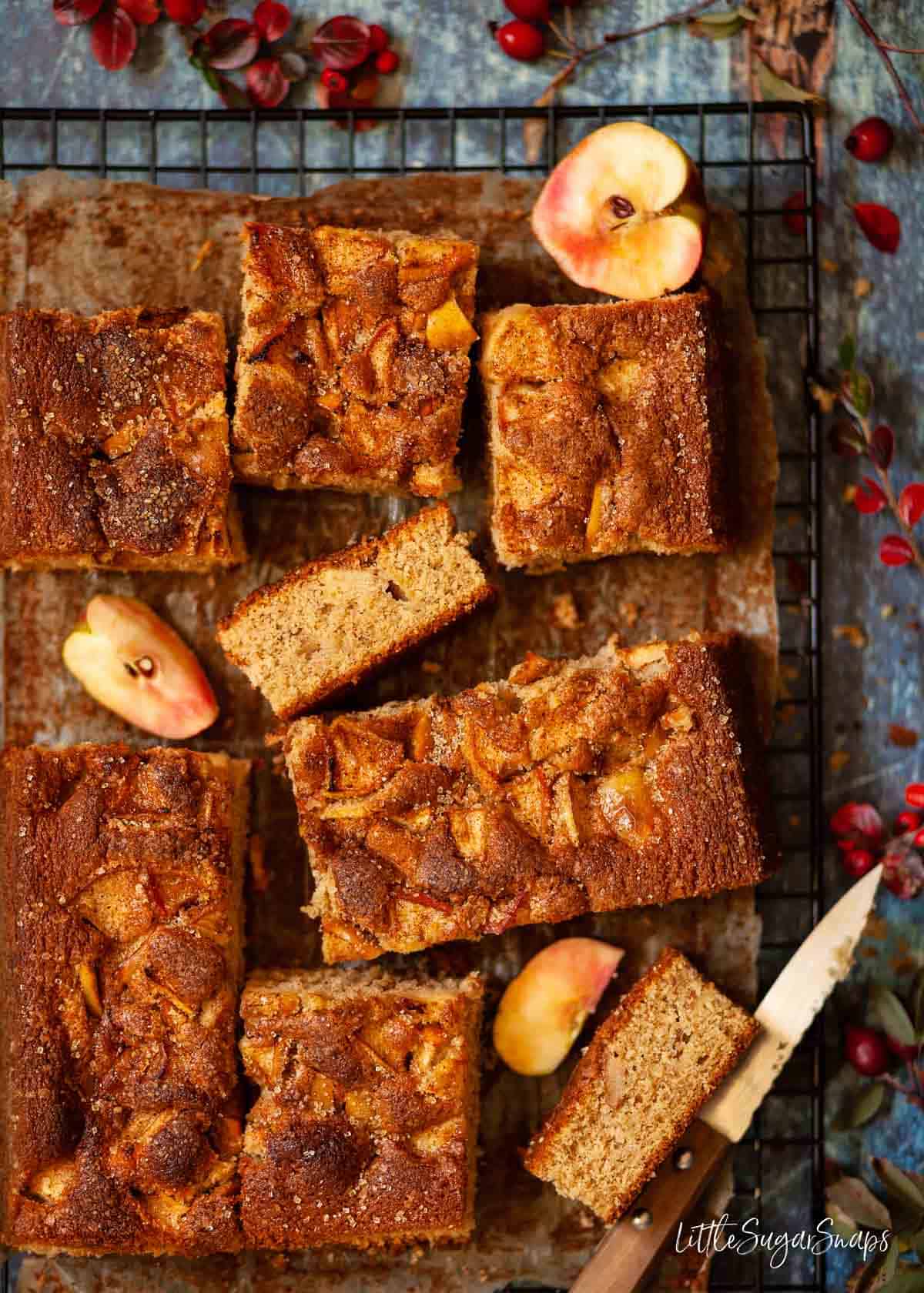 Spiced Apple traybake cake cut into pieces on a wire rack