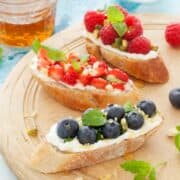 Mixed fruit breakfast bruschetta on a wooden platter