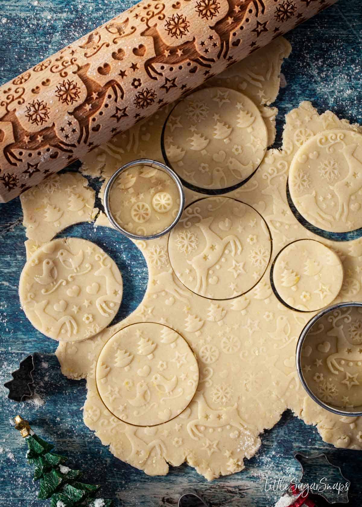 Embossed lemon shortbread cookies being cut out