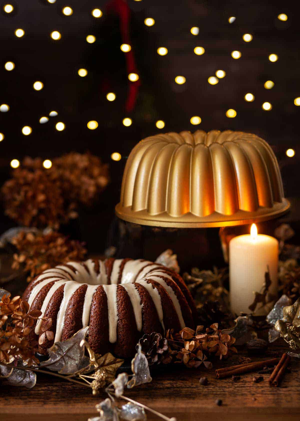 A pumpkin bundt cake with the baking tin behind