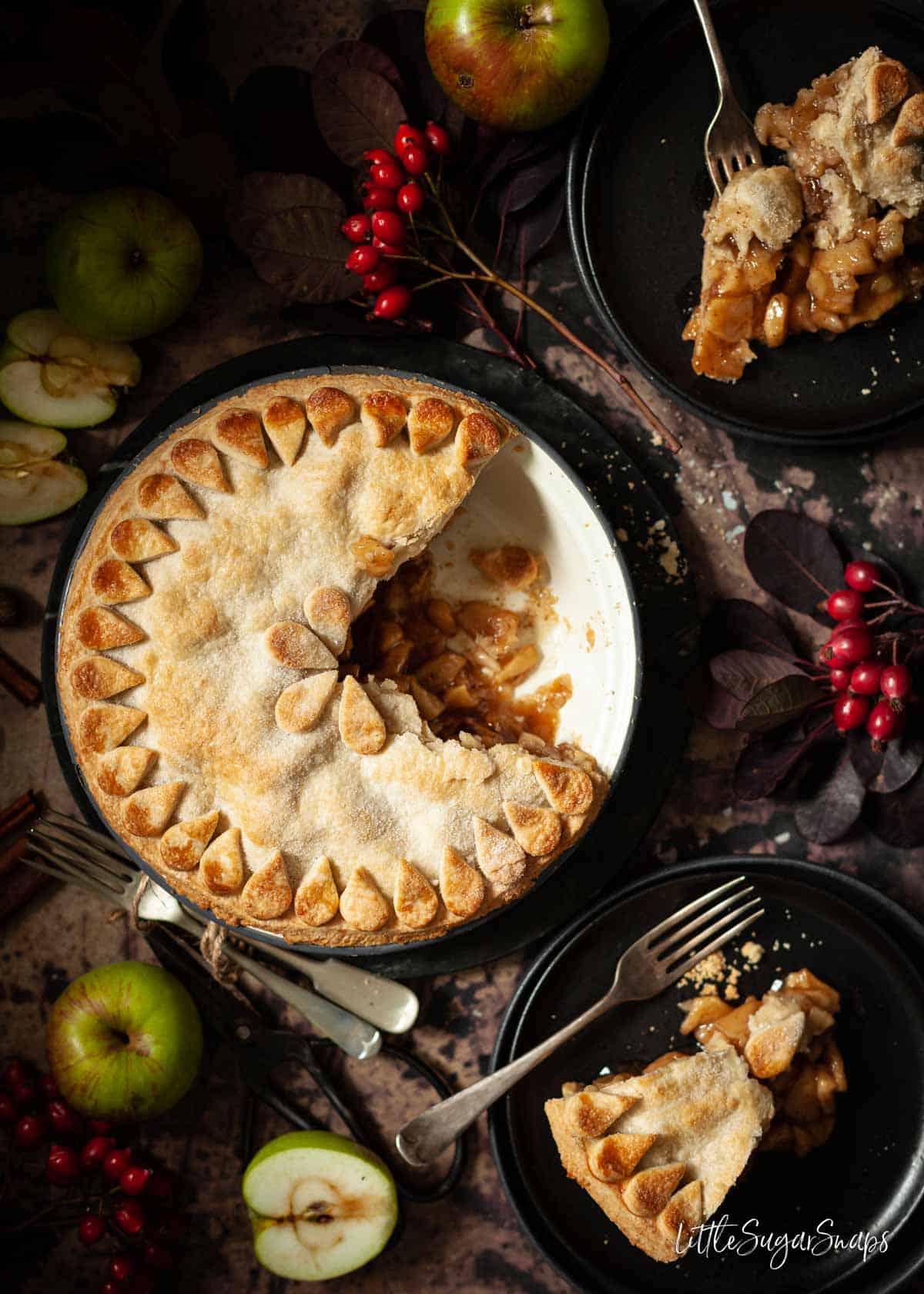 Vegan apple pie in a tin with several slices removed