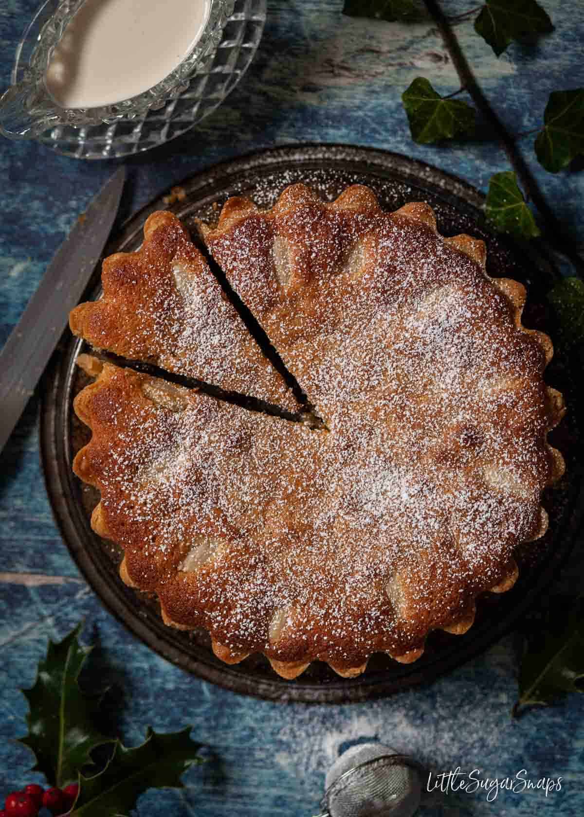 A family sized frangipane mince pie with a slice cut