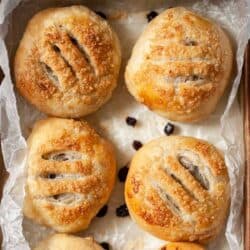 Four Eccles cakes on waxed paper