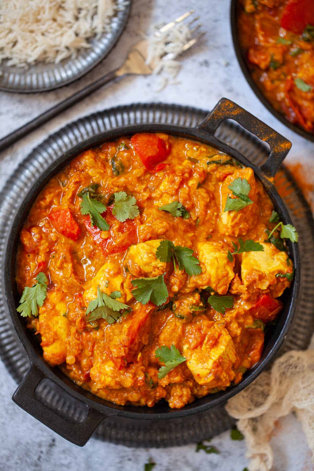 A skillet full of chicken lentil curry