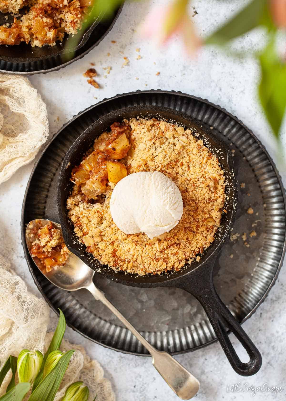 Pineapple crumble and vanilla ice cream in a cast iron skillet