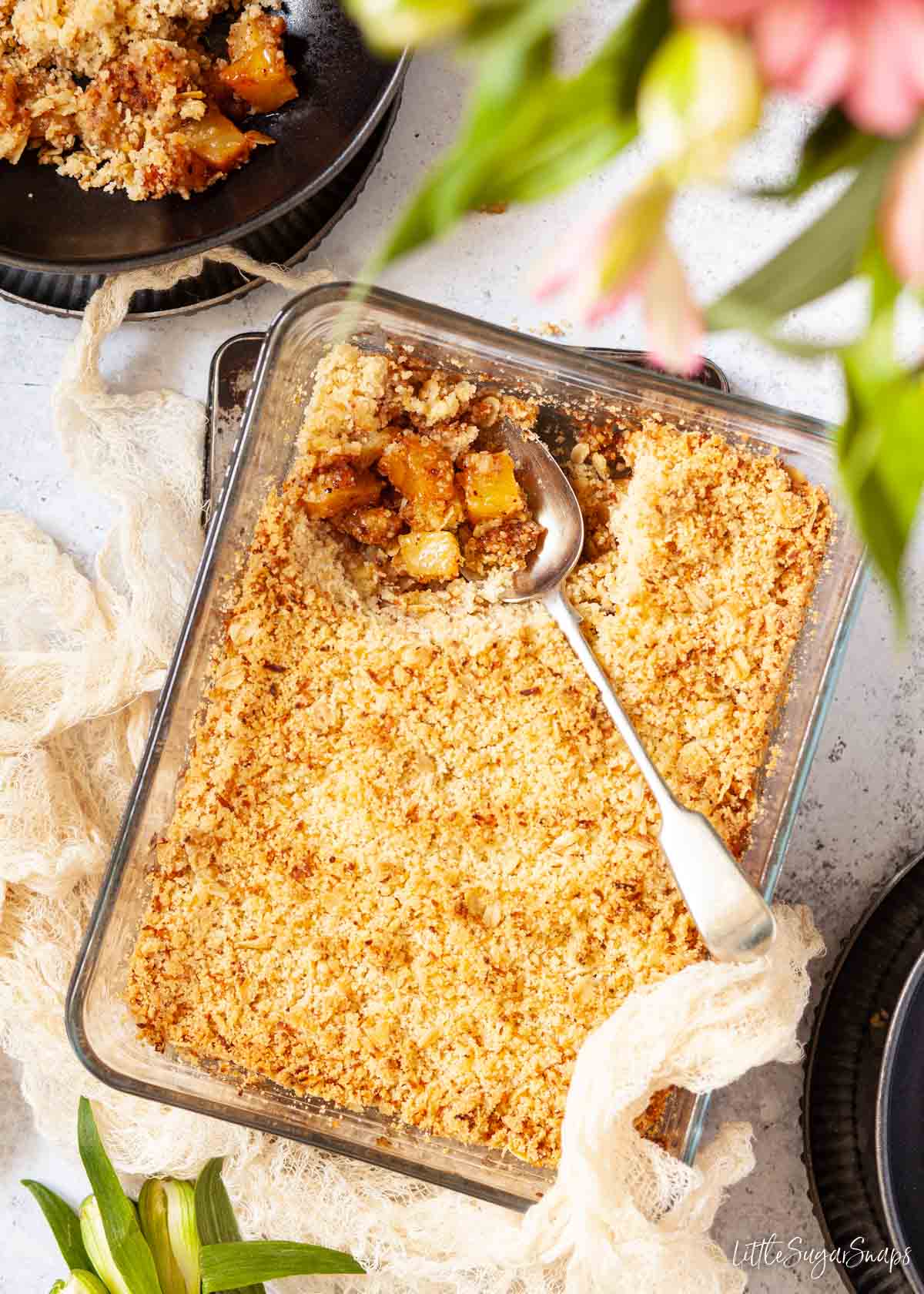 Pineapple crumble in a glass serving dish