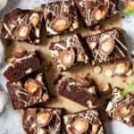 Squares of Easter themed brownies topped with chopped creme eggs