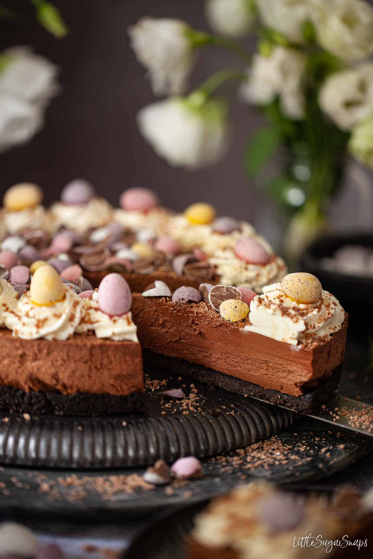 A slice of mini egg cheesecake being served