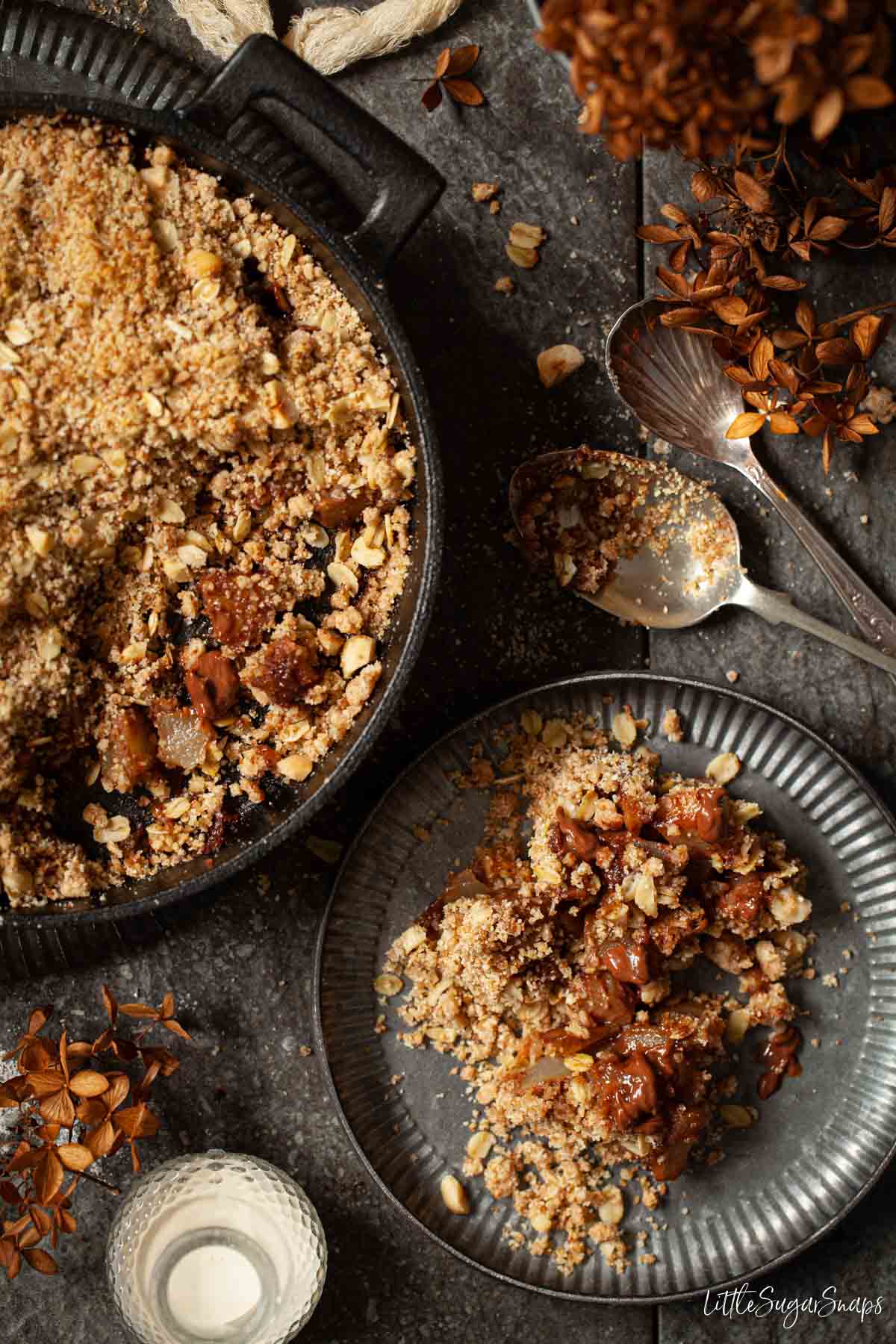 Chocolate and Pear crumble being served from a skillet onto plates