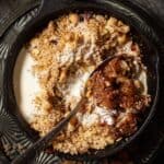 Pear crumble in a skillet with cream