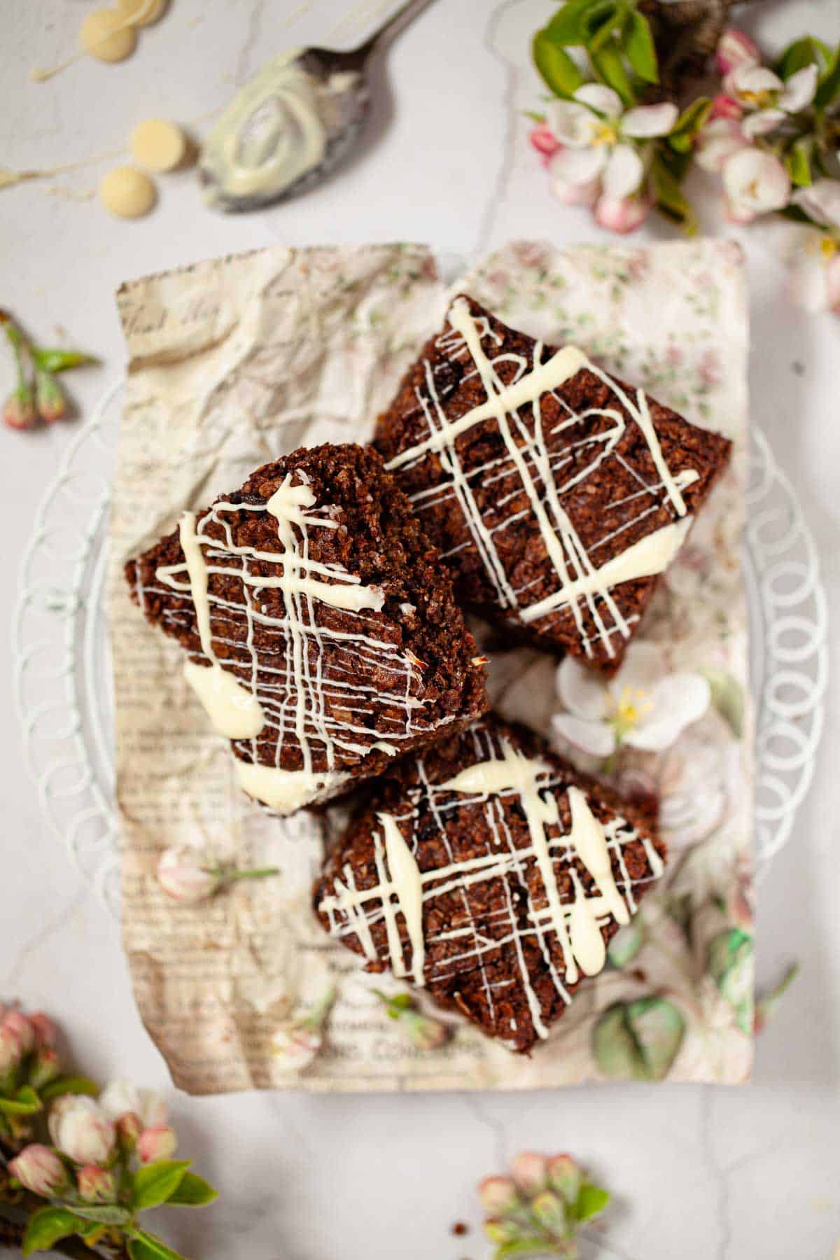 Three squares of chocolate flapjack on a wire rack