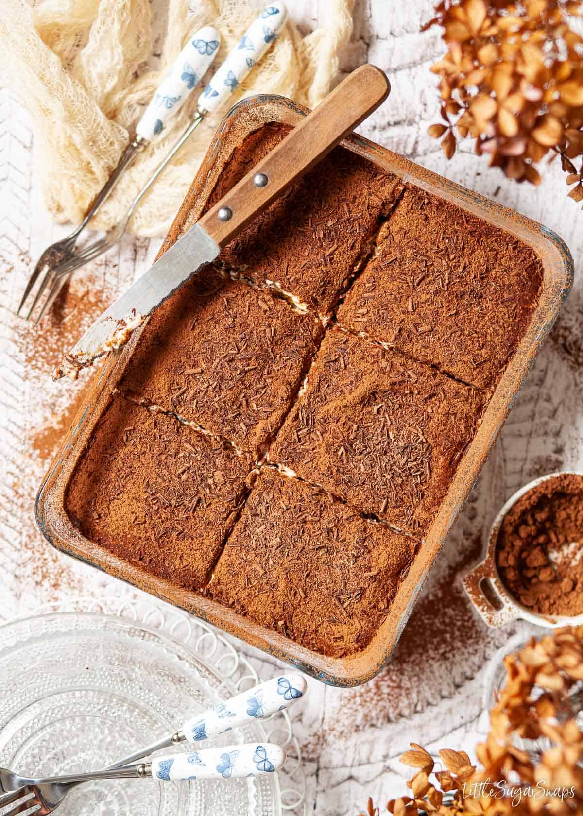 Tiramisu in a serving dish cut into portions