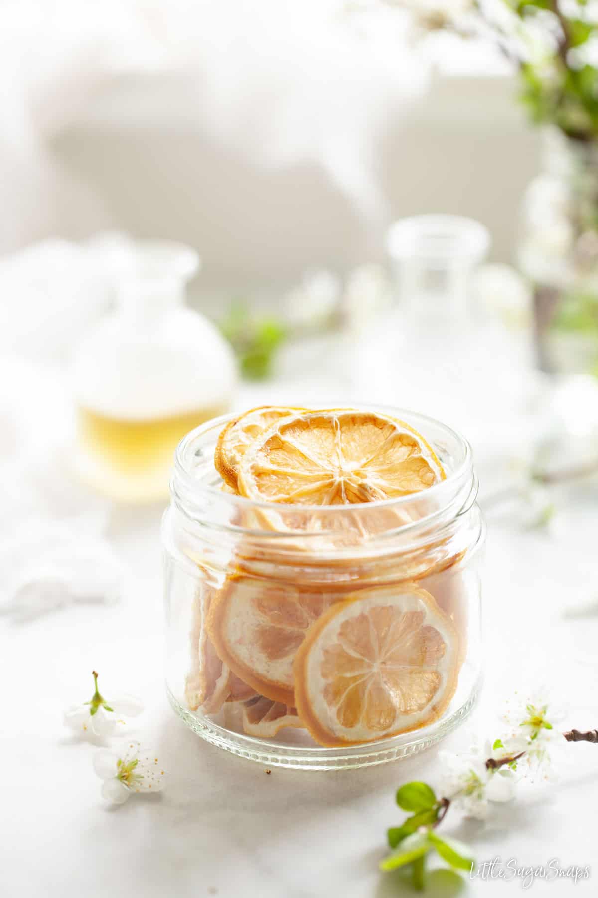 A jar of dehydrated lemon wheels suitable for cocktail or cake garnishes