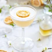 A gin sour with bergamot and camomile. Garnished with egg white foam and dehydrated lemon