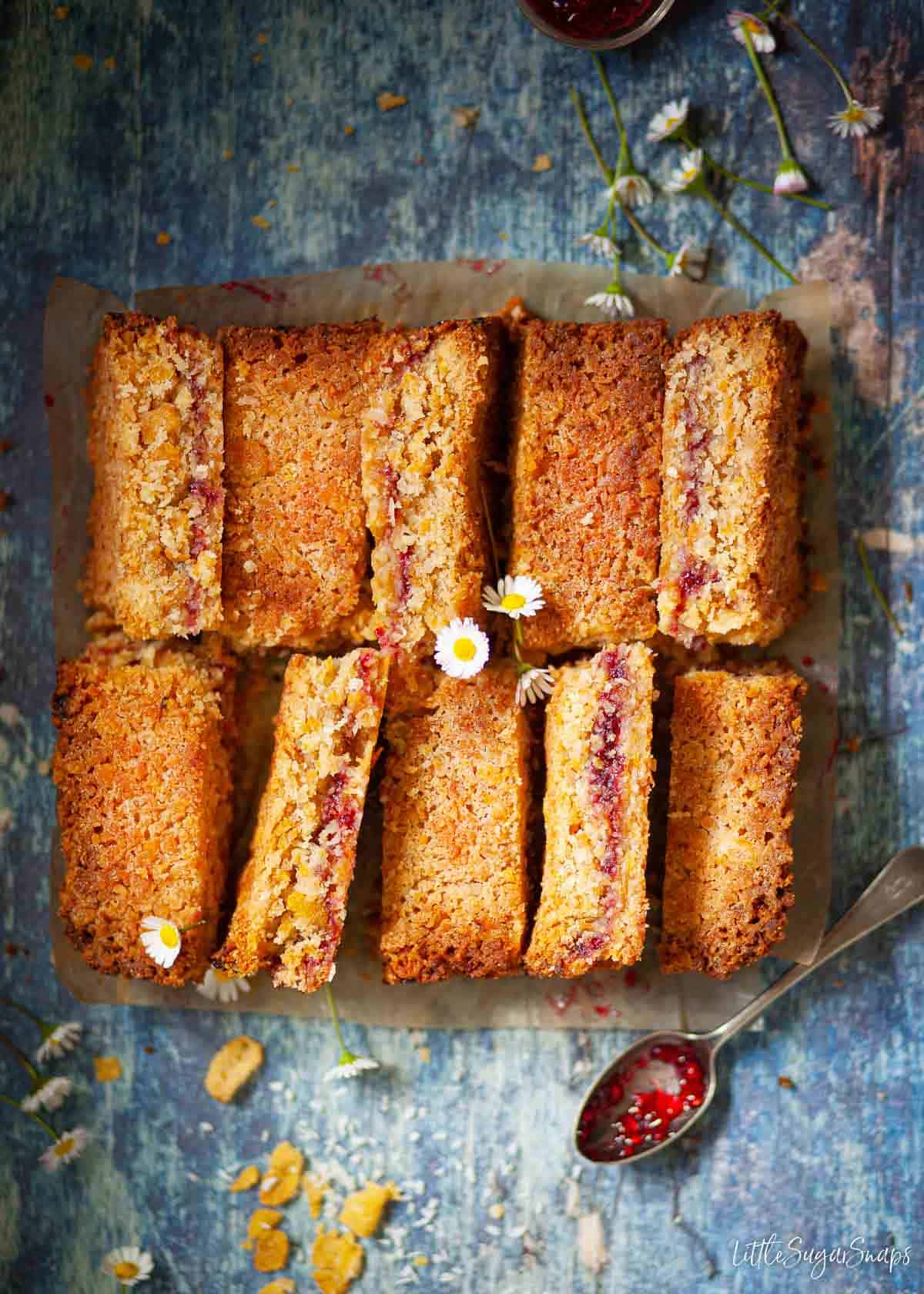 Cornflake slices with a jammy centre on a blue board