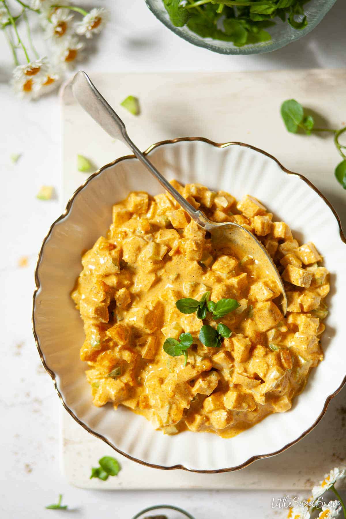 A bowl of coronation chicken sandwich filling