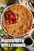 A bowl of blackberry and apple crumble with a portion removed with text overlay