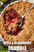 Close up of apple and blackberry crumble being served with text overlay