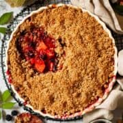 Close up of Apple and Blackberry Crumble in a serving dish - featured Image