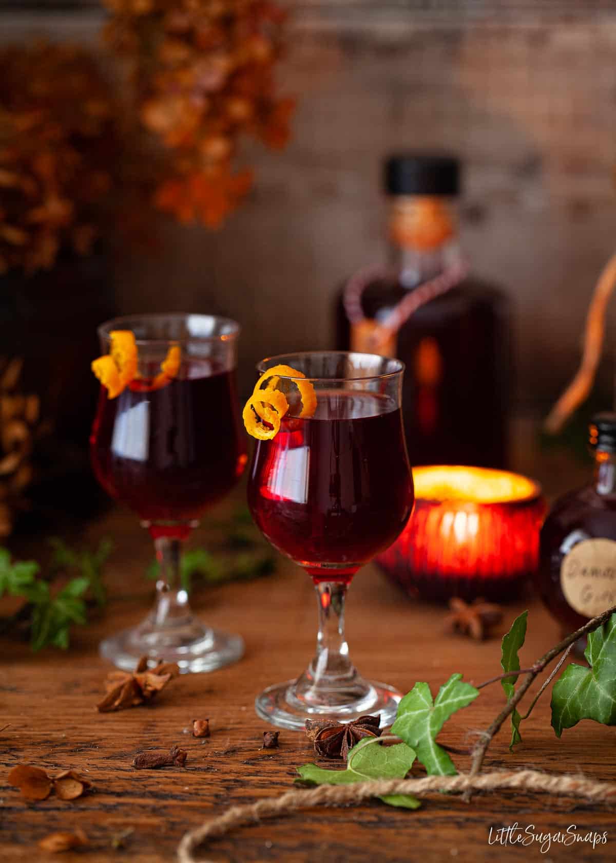 Glasses of damson gin served with a twist of orange