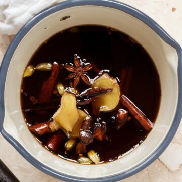 Close up of masala chai syrup infusing in a pan