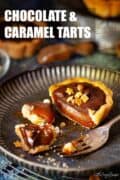 A cut open chocolate caramel tart with text overlay