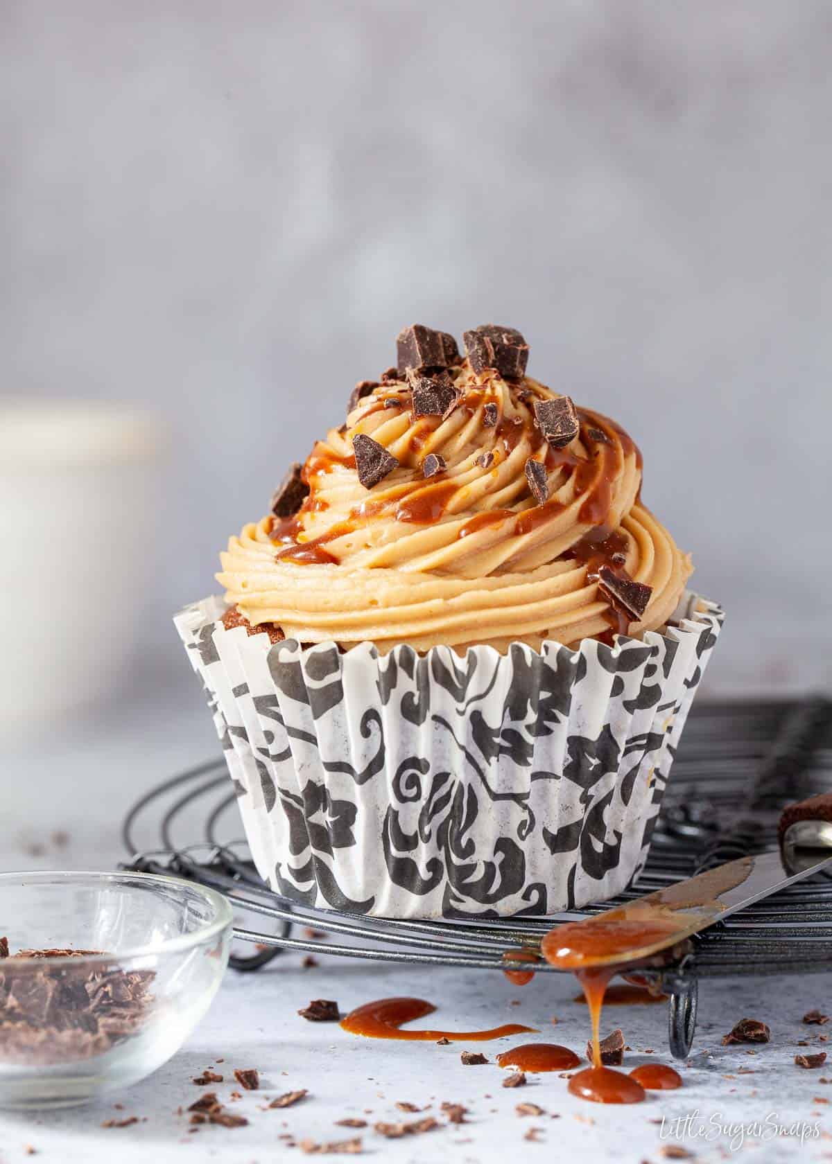 A small cake with coffee buttercream and coffee caramel drizzled on top.