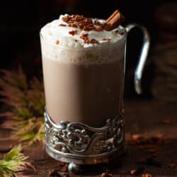 Close-up of a gingerbread latte with cream and sprinkles.