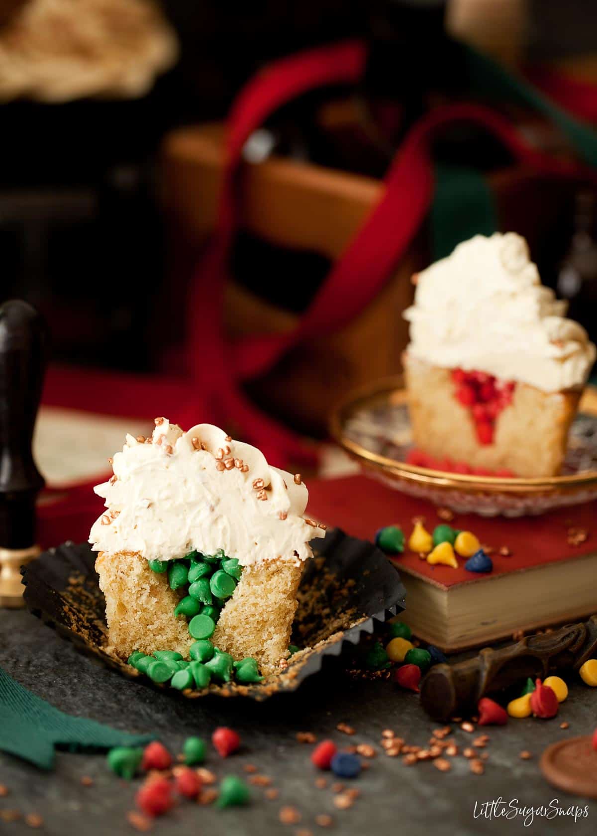 Cut open sorting hat cupcakes with Hogwarts house coloured filling inside