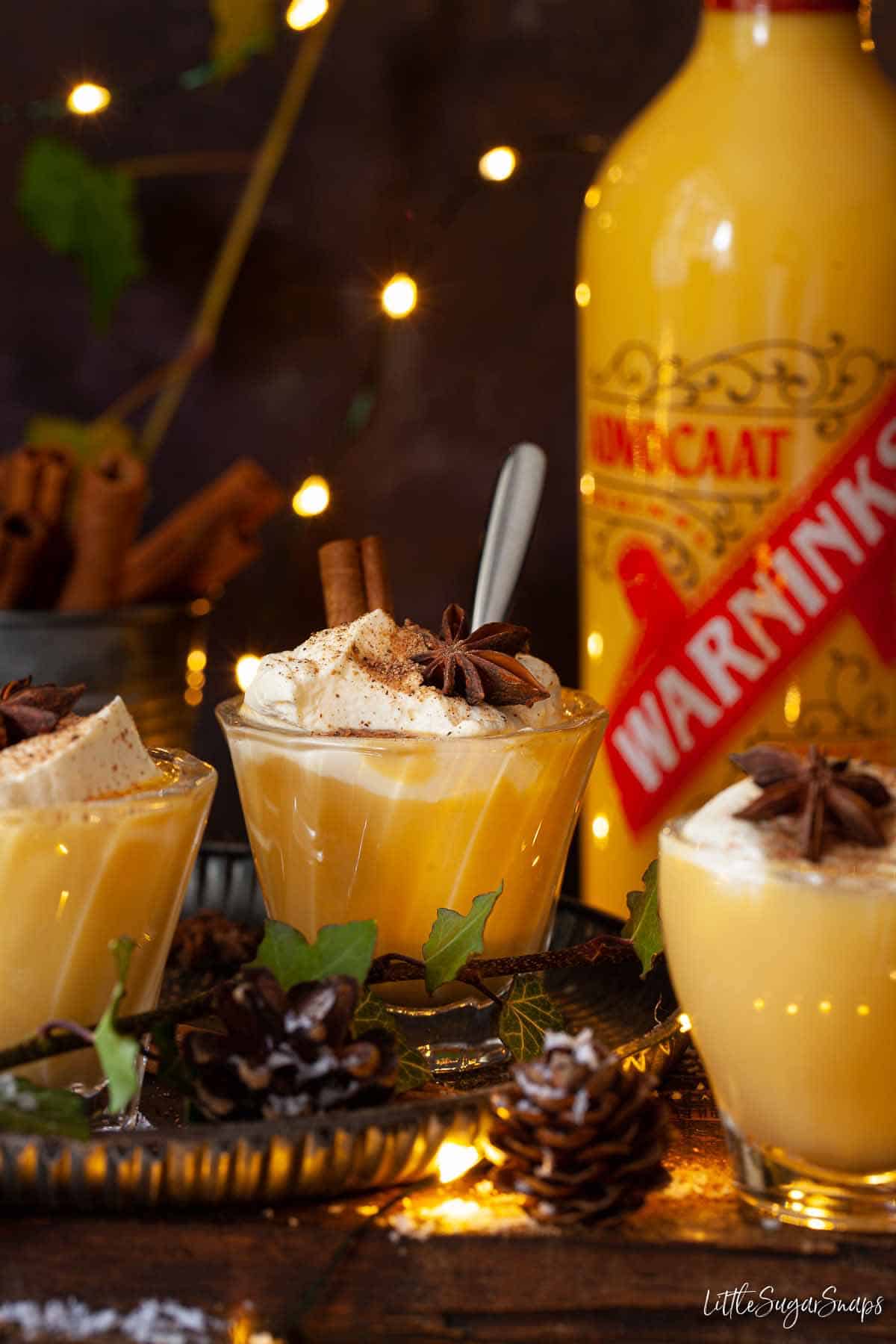 Advocaat bombardino drinks with a bottle of advocaat behind.