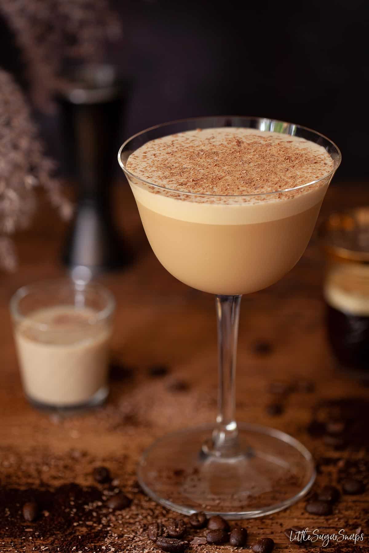 A coffee and Baileys cocktail topped with grated chocolate.