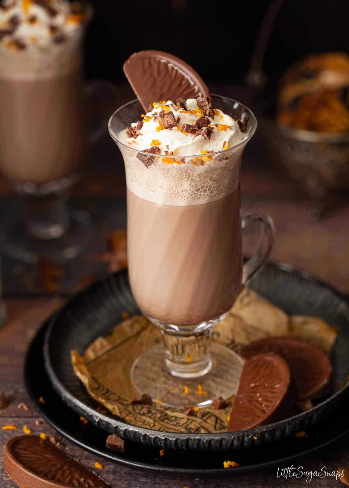 A hot chocolate topped with cream and a Terry's Chocolate Orange segment.